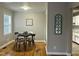 Cozy dining room with wood floors, a round table set for four, and natural light at 2331 Kennington Rd, Raleigh, NC 27610