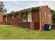 Exterior view of a brick home with a small back porch and green lawn at 2331 Kennington Rd, Raleigh, NC 27610