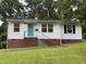Charming single-story home with brick foundation, a blue door, and a well-maintained lawn at 2331 Kennington Rd, Raleigh, NC 27610