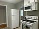 Modern kitchen appliances including a microwave, range, and refrigerator, perfect for cooking enthusiasts at 2331 Kennington Rd, Raleigh, NC 27610