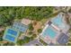 Aerial view of community amenities including a pool, tennis courts, and playground surrounded by lush trees at 2420 Rogerson St, Raleigh, NC 27614