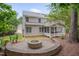 Enjoy outdoor living with this fire pit and hardscaped patio and screened in porch, all surrounded by mature trees at 2420 Rogerson St, Raleigh, NC 27614