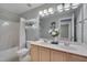 Bright secondary bathroom with double vanity, large mirror, and a shower-tub combo at 2420 Rogerson St, Raleigh, NC 27614