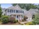Charming two-story home with blue shutters, manicured lawn, and attached two-car garage at 2420 Rogerson St, Raleigh, NC 27614