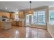 Spacious kitchen with hardwood floors, ample counter space, and a large window overlooking the backyard at 2420 Rogerson St, Raleigh, NC 27614