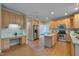Open kitchen with hardwood floors, stainless steel appliances, granite counters, and custom cabinetry at 2420 Rogerson St, Raleigh, NC 27614
