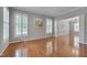 Spacious living room featuring hardwood floors, plantation shutters, and decorative trim at 2420 Rogerson St, Raleigh, NC 27614