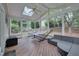 Relaxing screened porch with wooded views, skylights, ceiling fan, and seating area. A great place to entertain or unwind at 2420 Rogerson St, Raleigh, NC 27614