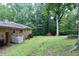 Spacious backyard featuring a brick house, lush greenery, and a shed for extra storage at 2440 Gardner Holt Rd, Burlington, NC 27215