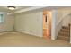 Finished basement with neutral carpet and stairwell at 2440 Gardner Holt Rd, Burlington, NC 27215