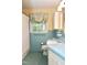 Charming blue bathroom featuring blue tile, leafy window curtains, and a tiled sink counter at 2440 Gardner Holt Rd, Burlington, NC 27215