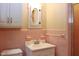 Charming bathroom featuring pink tiling and a classic vanity with storage cabinet at 2440 Gardner Holt Rd, Burlington, NC 27215