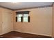 Bedroom featuring hardwood floors, wallpaper, a window with curtains and a closet with sliding doors at 2440 Gardner Holt Rd, Burlington, NC 27215