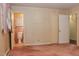 Bedroom featuring pink carpet, wallpaper, doorway and adjacent bathroom with complementary color palette at 2440 Gardner Holt Rd, Burlington, NC 27215