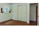 Cozy bedroom with hardwood floors, sliding closet doors and a window with decorative curtains at 2440 Gardner Holt Rd, Burlington, NC 27215