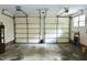 Two-car garage interior with exposed ceiling hardware, ample space, and a brick foundation at 2440 Gardner Holt Rd, Burlington, NC 27215