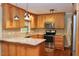Modern kitchen with granite countertops, stainless steel appliances, and custom wood cabinetry at 2440 Gardner Holt Rd, Burlington, NC 27215