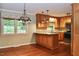 Well-lit kitchen featuring custom wood cabinets, granite countertops, and modern appliances at 2440 Gardner Holt Rd, Burlington, NC 27215