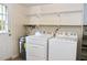 Functional laundry room with washer, dryer, shelving, and access door at 2440 Gardner Holt Rd, Burlington, NC 27215