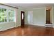 Inviting living room with gleaming hardwood floors and an elegant wooden front door at 2440 Gardner Holt Rd, Burlington, NC 27215
