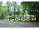 Secluded pond view from gated entrance, surrounded by mature trees and lush greenery at 2440 Gardner Holt Rd, Burlington, NC 27215