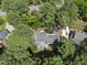 Aerial view of a house nestled amongst trees, highlighting its private location and well-maintained surroundings at 2704 Farnborough Rd, Raleigh, NC 27613