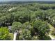 A home seen from above, surrounded by lush greenery, showcasing the spacious landscape and neighborhood setting at 2704 Farnborough Rd, Raleigh, NC 27613