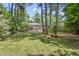 Expansive backyard with lush greenery and mature trees provides a serene and private outdoor space at 2704 Farnborough Rd, Raleigh, NC 27613