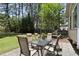 Well-maintained backyard featuring stone patio with dining set, providing a perfect space for outdoor entertaining at 2704 Farnborough Rd, Raleigh, NC 27613