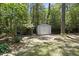 Spacious backyard with mature trees and two storage sheds, perfect for outdoor activities and storage solutions at 2704 Farnborough Rd, Raleigh, NC 27613