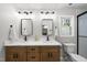 Bright bathroom with double vanity, modern fixtures, white countertop and an adjacent toilet at 2704 Farnborough Rd, Raleigh, NC 27613