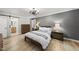 Spacious bedroom with wood-look floors and a modern ceiling fan at 2704 Farnborough Rd, Raleigh, NC 27613