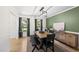 Dining room with wooden table, black chairs, and olive green accent wall at 2704 Farnborough Rd, Raleigh, NC 27613