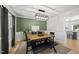 Dining room with wooden table, black chairs, and olive green accent wall at 2704 Farnborough Rd, Raleigh, NC 27613