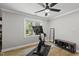 Bright exercise room featuring modern cycling machine, weights, and a ceiling fan for comfortable workouts at 2704 Farnborough Rd, Raleigh, NC 27613