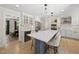 Open concept kitchen with white cabinets, stainless steel appliances, and an island with seating for three at 2704 Farnborough Rd, Raleigh, NC 27613