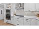 White kitchen with stainless steel appliances at 2704 Farnborough Rd, Raleigh, NC 27613