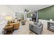 Bright living room featuring a fireplace, hardwood floors, and stylish furniture at 2704 Farnborough Rd, Raleigh, NC 27613