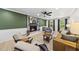 Living room with fireplace, ceiling fan and large windows at 2704 Farnborough Rd, Raleigh, NC 27613