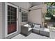 Cozy outdoor patio featuring comfortable seating, a view of the home's exterior, and plenty of natural light at 2704 Farnborough Rd, Raleigh, NC 27613