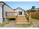 Wood deck and stairs leading to the backyard, complemented by mature trees at 2803 Atlantic St, Durham, NC 27707