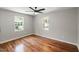Bedroom with hardwood floors, ceiling fan and two large windows at 2803 Atlantic St, Durham, NC 27707