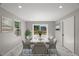 Dining room features virtual staging, with a gray table and chairs set at 2803 Atlantic St, Durham, NC 27707