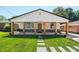 Charming home featuring a covered porch with wooden beams, stone accents, and a well-manicured lawn at 2803 Atlantic St, Durham, NC 27707