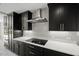 Modern kitchen features sleek black cabinets, stainless steel appliances, and quartz countertops at 2803 Atlantic St, Durham, NC 27707