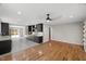 Open-concept layout showcasing the kitchen and adjacent living area with hardwood floors and fresh paint at 2803 Atlantic St, Durham, NC 27707
