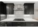 Modern kitchen features black cabinets, white countertops, and a stainless steel range hood at 2803 Atlantic St, Durham, NC 27707
