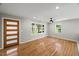 Spacious living room with hardwood floors, neutral walls, and a stylish ceiling fan at 2803 Atlantic St, Durham, NC 27707