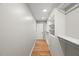 Open walk-in closet with long hanging rods, shelves, drawers, and hardwood floors at 2803 Atlantic St, Durham, NC 27707