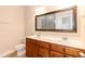 Bathroom with wood vanity, dual sinks, and a large mirror at 2808 Carter Finley Pl, Raleigh, NC 27606